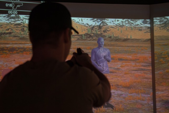 A Green Beret with 10th Special Forces Group (Airborne) fires at a target in the VirTra simulator on Fort Carson, Colorado, Feb. 2, 2024. The VirTra simulator features technology that can present different shooting scenarios, environments and targets to better help its users sharpen their shooting skills while providing realistic training.
