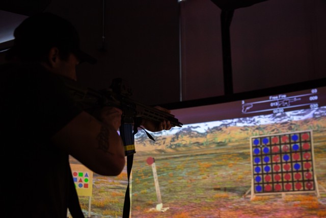 A Green Beret with 10th Special Forces Group (Airborne) shoots at different targets in the VirTra simulator on Fort Carson, Colorado, Feb. 2, 2024. The Green Berets were able to experiment with different weapon systems, targets and environments before conducting a shooting scenario.