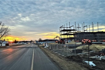 Dusk and sunset are shown behind the construction area for a new $28.08 million barracks building is shown Feb. 6, 2024, at Fort McCoy, Wis., as the fra...