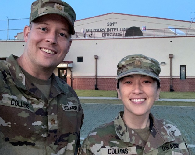 Majs. Andrew and Liz Collins take a selfie in front of the 501st Military Intelligence Brigade building, U.S. Army Intelligence and Security Command, South Korea. Andrew served as the operations officer for the brigade while Liz served as the brigade and battalion executive officer.