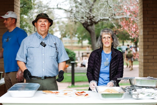 John and Martha Stoltz, Wings Chapel volunteers, serve pancakes to participants of the Ruck to Remember event at Fort Novosel on Feb. 10, 2024. 