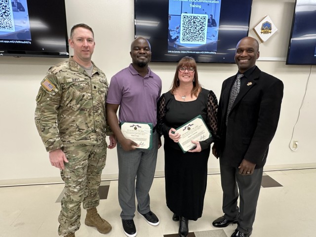 Garrison Commander Lt. Col. Jason Duffy and Deputy Commander Mr. Scott pose with Instructors Brian Rush and Farrah Overman after they were presented Army Civilian Service Achievement Medals.  