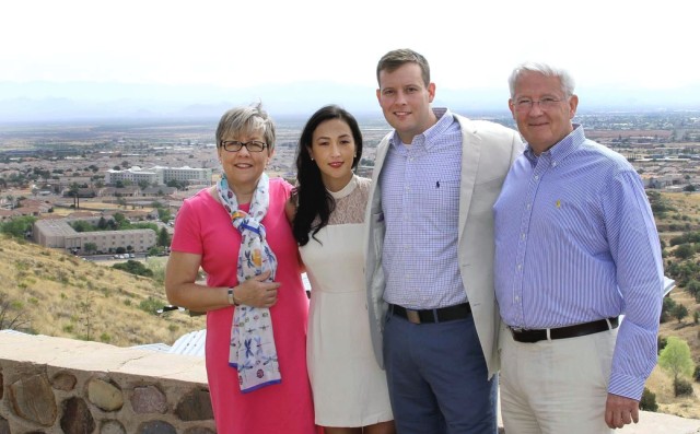 Katie Collins, Maj. Liz Collins, Maj. Andrew Collins, and John Collins pose for a photo after Liz and Andrew exchanged wedding vows at the top of Reservoir Hill at Fort Huachuca in Arizona. Katie and John are Andrew&#39;s parents.