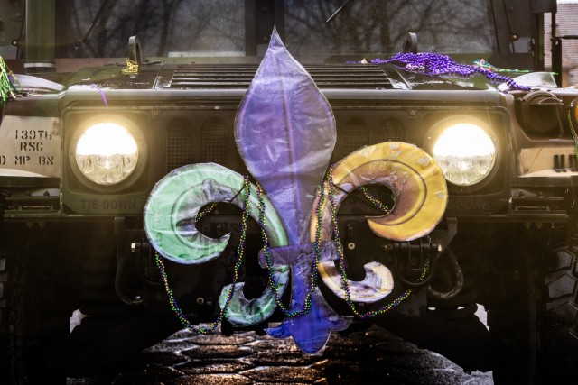 A humvee is seen adorned with a Fleur-de-lis in traditional Mardi Gras colors during a Mardi Gras celebration at Camp Kosciuszko in Poznan, Poland, Feb. 9, 2024. The event was hosted by the 773rd Military Police Battalion, a Louisiana Guard Unit based out of Pineville. The unit has spent the past year providing security and law enforcement capabilities to U.S. Army Garrison Poland.