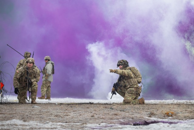 A Soldier from 2nd Battalion, 22nd Infantry Regiment, 1st Brigade Combat Team, 10th Mountain Division, directs his squad under the cover of smoke during a combined-arms live-fire exercise Feb. 6, 2024, on Fort Drum, New York. Combined-arms live-fire exercises provide a unique opportunity to validate combat effectiveness and the ability to thrive and operate in austere environments. (U.S. Army photo by Spc. Salvador Castro)