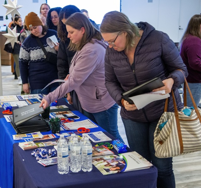 Fort Belvoir homeschool parents browse resources on hand after a high school preparation workshop at the USO Warrior and Family Center, Jan. 18.