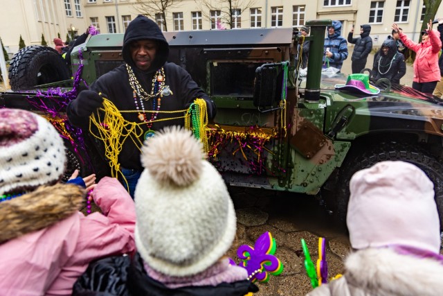 A soldiers from the 773rd Military Police Battalion hands out Mardi Gras goodies during the very first Mardi Gras parade across Camp Kosciuszko in Poznan, Poland, Feb. 9, 2024. The 773rd MP Bn., a Louisiana Guard Unit based out of Pineville, has spent the past year providing security and law enforcement capabilities to U.S. Army Garrison Poland.
