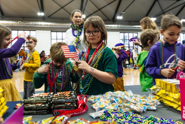 A Polish elementary school student checks out American treats at Camp Kosciuszko in Poznan, Poland, Feb. 9, 2024 during a Mardi Gras celebration. The event was hosted by the 773rd Military Police Battalion, a Louisiana Guard Unit based out of Pineville. The unit has spent the past year providing security and law enforcement capabilities to U.S. Army Garrison Poland.