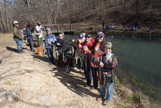Participants at the 2023 Kid’s Trout Fishing Derby show off their catches at the Stone Mill Spring Recreation Area. This year’s event is set to take place Feb. 24.