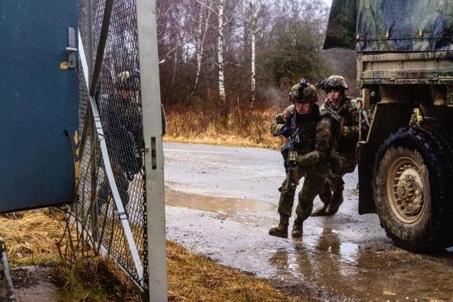 U.S. Army Spc. William Brust attached to 2nd Cavalry Regiment (2CR), 2nd squadron, breaches enemy security compound with his squad during a Simulated Training Exercise (STX) held by 2CR at Vilseck, Germany Feb. 7, 2024. During the STX soldiers...