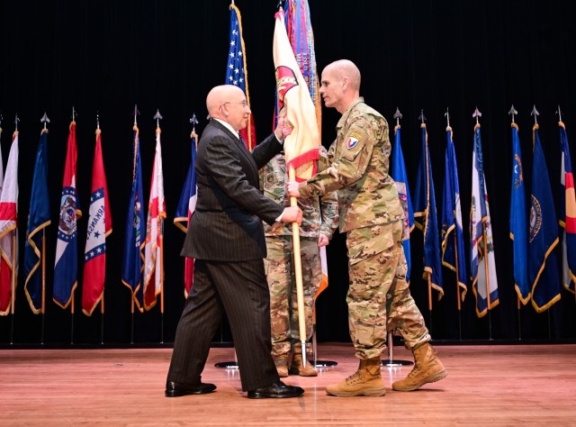 Lt. Gen. Omar Jones, right, IMCOM commanding general, passes the IMCOM guidon to IMCOM-Training Director William Kidd during the Assumption of Responsibility ceremony Feb. 7 at Joint Base Langley-Eustis, Virginia.