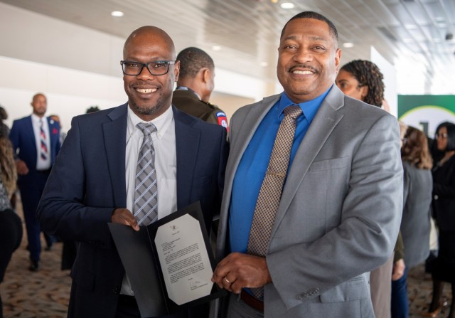 Dr. Eric Moore, U.S. Army Combat Capabilities Development Command, or DEVCOM, Deputy to the Commanding General, right, and Dax Cadet, DEVCOM Command, Control, Communications, Computers, Cyber, Intelligence, Surveillance and Reconnaissance Center, left, pose for a photo Feb. 17, 2024, at the Baltimore Convention Center in Baltimore, Maryland. Mims received the Black Engineer of the Year Awards in Science, Technology, Engineering and Math Science Spectrum Trailblazer award. 