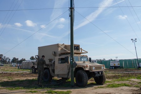 Military personnel and civilians prepare vehicles to assist in experimentation for Project Convergence Capstone 4 at Camp Pendleton, Calif., Feb. 15, 2024. The U.S. Army will host PC-C4, a Joint, Multinational, “in-the-dirt: experiment from Feb. 23 - March 20, 2024. PC-C4 participants include the U.S. Army, U.S. Navy, U.S. Air Force, U.S. Marine Corps, and U.S. Space Force along with militaries from partner and allied countries from the United Kingdom, Australia, Canada, New Zealand, France, and Japan. Conducted in two phases, PC-C4 is a culmination of numerous preceding exercises, experimentations, and events; it provides a critical venue to identify and refine recommendations necessary to transform the Army and ensure future war-winning readiness. 
