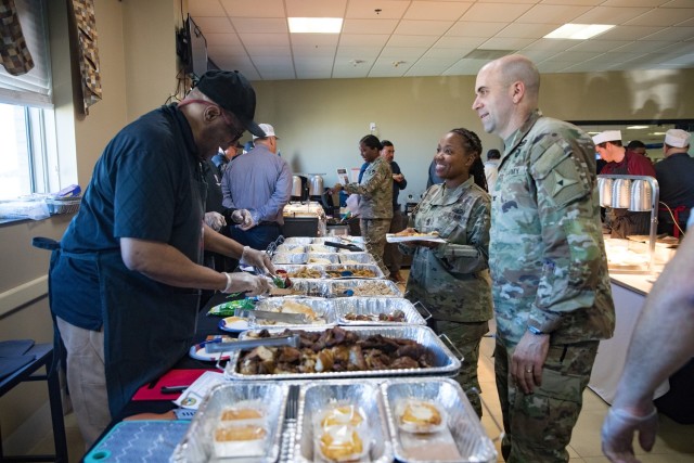 A vendor plates food to give to Sgt. Maj. Kresassidy McKinney, III Armored Corps chief culinary sergeant major, and Col. Kevin Agness, III Armored Corps director of logistics, Feb. 13 during the Culinary Vendor Showcase at Black Jack Dining Facility. Attendees could sample more than 100 different food items during the event. (U.S. Army photo by Blair Dupre, Fort Cavazos Public Affairs) 