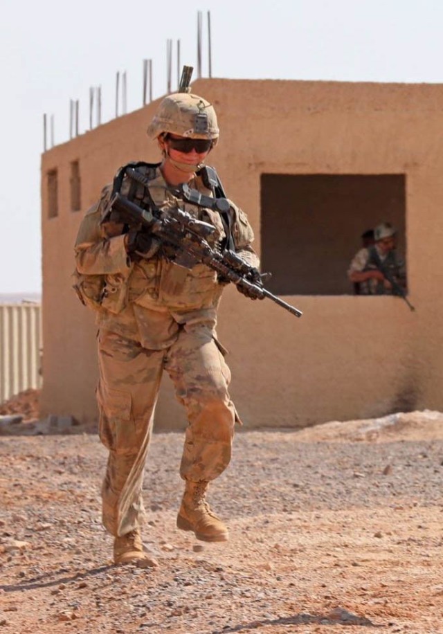 U.S. Army Pfc. Stacey Collins, an infantry Soldier with 3rd Armored Brigade Combat Team, 4th Infantry Division, patrols while deployed to Jordan, Aug. 2019. Collins later changed her military occupational specialty to military working dog handler, and is now a part of 8th Military Police Brigade, 8th Theater Sustainment Command. (Courtesy) 
