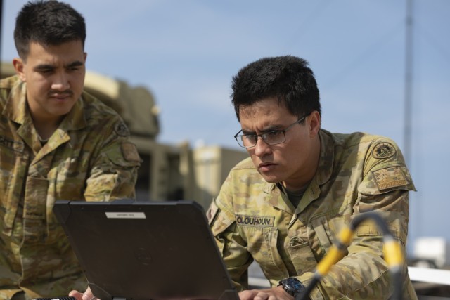 Harley Leggett and Lachcan Cocqunoun, members of the Australian Defense Force, assigned to the 3 combat signals regiment, set up a communications tower during Project Convergence - Capstone 4 at Camp Pendleton Calif. Compared to previous Project...