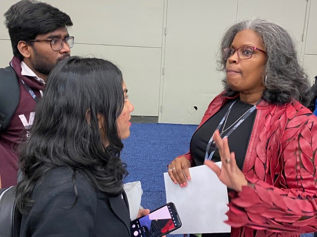 Gayna Malcolm-Packnett, right, from the Army Office of Small Business Programs, speaks with two students during the BEYA Conference in Baltimore.