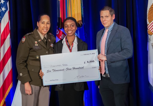 U.S. Army Lt. Col. Sherida Whindleton, deputy director of Army Prize Competitions and the Army Applied Small Business Innovation Research (SBIR) Program, and Dr. Matt Willis, director of Army Prize Competitions and the Army Applied SBIR Program, present Osariemen Nosa with a check after winning 3rd place in the xTechHBCU Student Competition at the Center of Influence event, hosted by the U.S. Army, during the 38th Annual Becoming Everything You Are, Science, Technology, Engineering and Mathematics (BEYA STEM) Conference, in Baltimore, Md., Feb. 17, 2024. (U.S. Army photo by Spc. Joseph Martin)