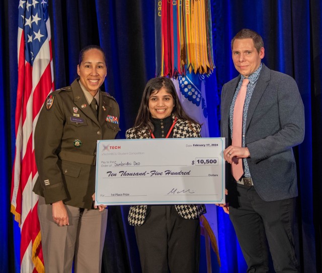 U.S. Army Lt. Col. Sherida Whindleton, deputy director of Army Prize Competitions and the Army Applied Small Business Innovation Research (SBIR) Program, and Dr. Matt Willis, director of Army Prize Competitions and the Army Applied SBIR Program, present Sambridhi Deo with a check after winning 1st place in the xTechHBCU Student Competition at the Center of Influence event, hosted by the U.S. Army, during the 38th Annual Becoming Everything You Are, Science, Technology, Engineering and Mathematics (BEYA STEM) Conference, in Baltimore, Md., Feb. 17, 2024. (U.S. Army photo by Spc. Joseph Martin)