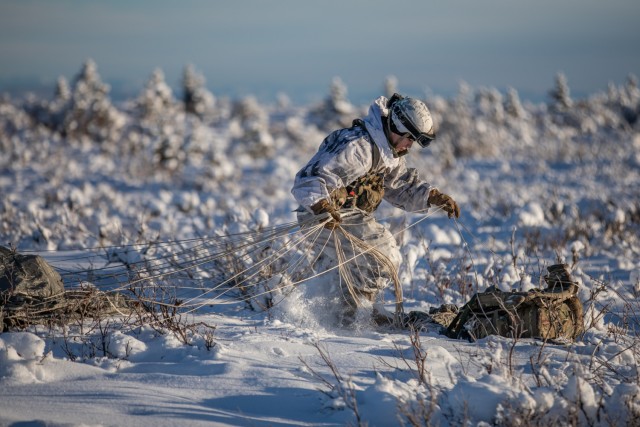 Pfc. Danville Aguirre, 3rd Battalion, 509th Parachute Infantry Regiment, 2nd Infantry Brigade Combat Team, 11th Airborne Division, packs up his parachute after an airborne operation as part of Joint Pacific Multinational Readiness Center 24-02 at the Donnelly Training Area, Alaska, Feb. 8, 2024. 