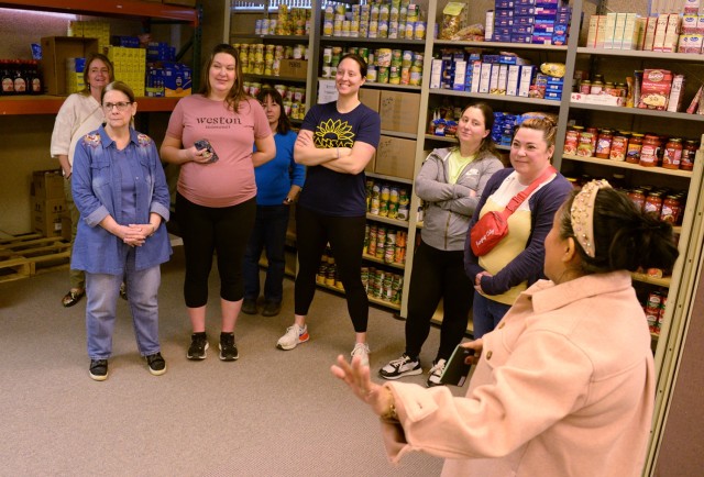 Stronghold Food Pantry Founder and CEO Monica Bassett shows volunteers where food and other items are kept, while sharing with them some of the pantry’s procedures, during a volunteer orientation session Feb. 21, 2024, in the basement of Armed...