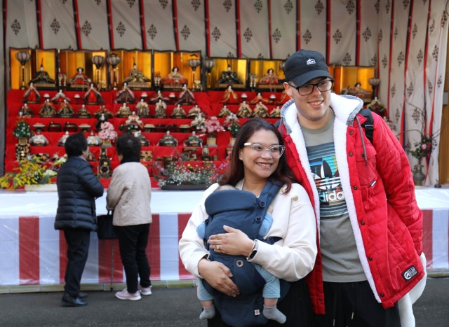 Spc. Jean Leon, right, a dental assistant for U.S. Army Dental Health Activity-Japan, and his wife, Joselyn Miranda pose for a photo with their son, Aaron, in front of a doll display in celebration of the Dolls Festival, or &#34;Hinamatsuri,&#34;...