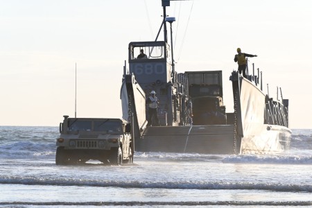 U.S. Navy Sailors assigned to Beachmaster Unit 1 and the Amphibious Construction Battalion train during the transportation of equipment and troops from a Landing Craft Utility as part of Project Convergence - Capstone 4 at Camp...