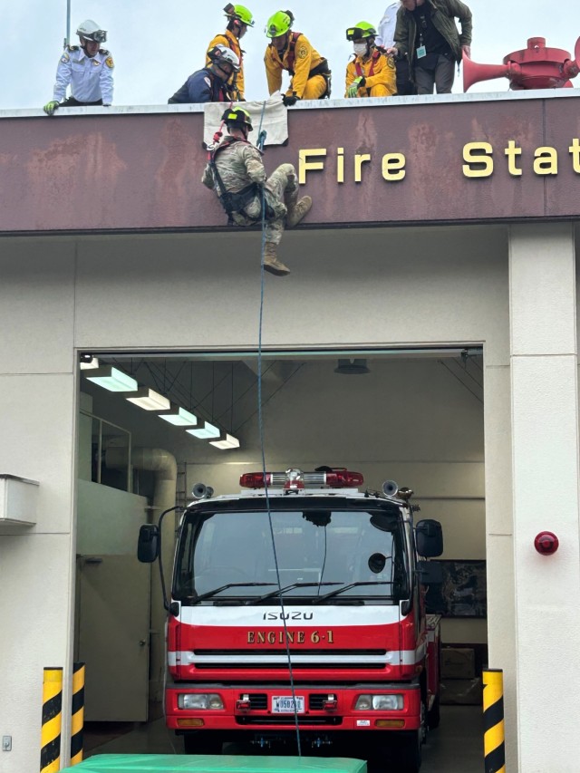 Col. Marcus Hunter, U.S. Army Garrison Japan commander, rappels off of the fire station at the Kawakami Ammunition Depot during a recent trip to the Kure Ammunition District in Hiroshima, Japan.