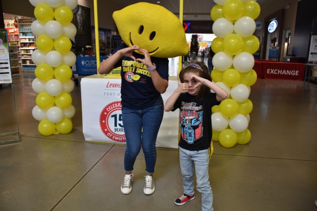 Five-year-old Alex Plamadeala poses with Miss Lemonhead during the Lemonade Day registration event Feb. 24, 2024, at the Clear Creek Main Exchange. (U.S. Army photo by Janecze Wright, Fort Cavazos Public Affairs)