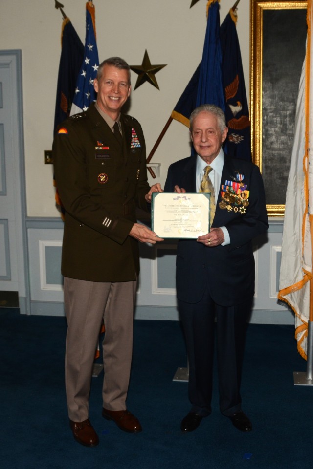 Gen. Daniel Hokanson, left, chief of the National Guard Bureau, presents retired Army Capt. Larry Liss with a Silver Star citation during a ceremony March 5, 2024, at Valley Forge Military Academy in Wayne, Pa. Liss received the medal, an upgrade from a Distinguished Flying Cross, for rescuing more than 80 U.S. and South Vietnamese soldiers during the Vietnam War.