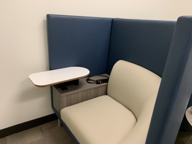 One of two private stations in the room, with comfortable seating, power cord, and table