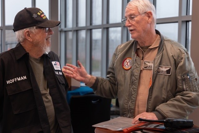 Korean War veteran Duane Hoffman and retired Lt. Col. Jim Burch, a pilot with the Rocket City Wing of the Commemorative Air Force, go over a preflight safety briefing.