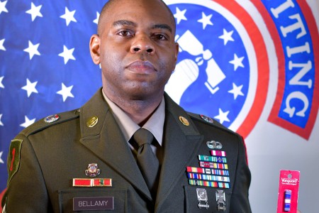 Master Sgt. Andra Bellamy holds the recruiting ribbon in his hand.