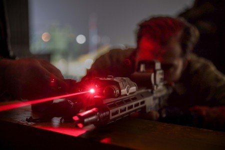 An Army Green Beret adjusts a laser sight to engage targets in low light conditions during Trojan Footprint 2024 near Sofia, Bulgaria, March 1, 2024. Exercise Trojan Footprint provides NATO allies and partner special operations forces an...