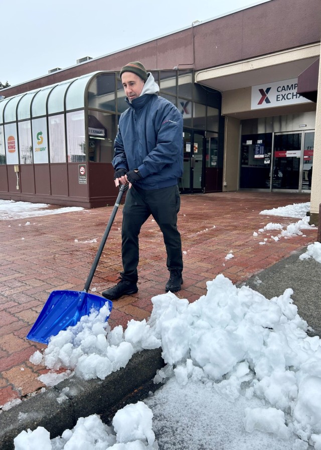 Nick Cucinello, Camp Zama Army and Air Force Exchange Service general manager, shovels snow in front of the Camp Zama AAFES store Feb. 6, 2024, after heavy snow and slush covered the Kanto Plain. The community remained prepared for the event thanks to the hard work of a joint weather council.