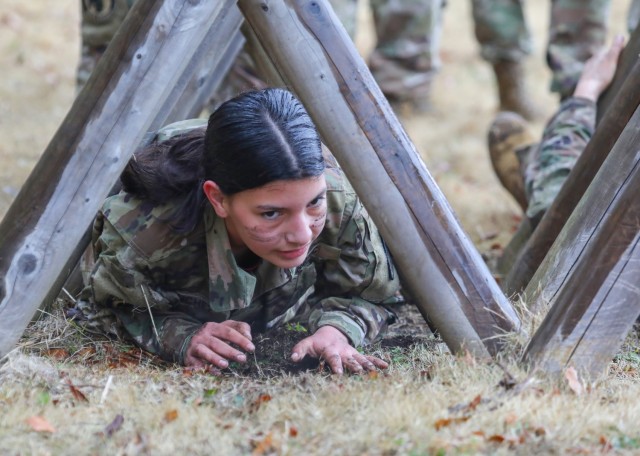 Cadet Chelsea Sanchez crawls through an obstacle while completing a confidence course at Camp Zama, Japan, March 12, 2024. Soldiers from the 35th Combat Sustainment Support Battalion hosted a field day to familiarize Zama Middle High School cadets...