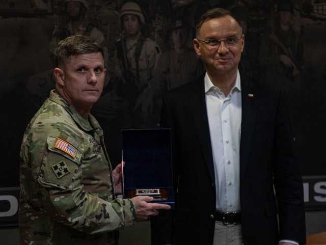 Polish President Andzrej Duda presents a gift to U.S. Army Brig. Gen. Jeremy Wilson, 3rd Infantry Division’s (3ID) Deputy Commanding General of Maneuver at Fort Stewart, Georgia, March 13, 2024. Duda’s visit comes as multiple 3ID units are currently deployed in the Baltic region as part of the strong unremitting U.S. commitment to NATO. (U.S. Army photo by Pfc. Rebeca Soria)