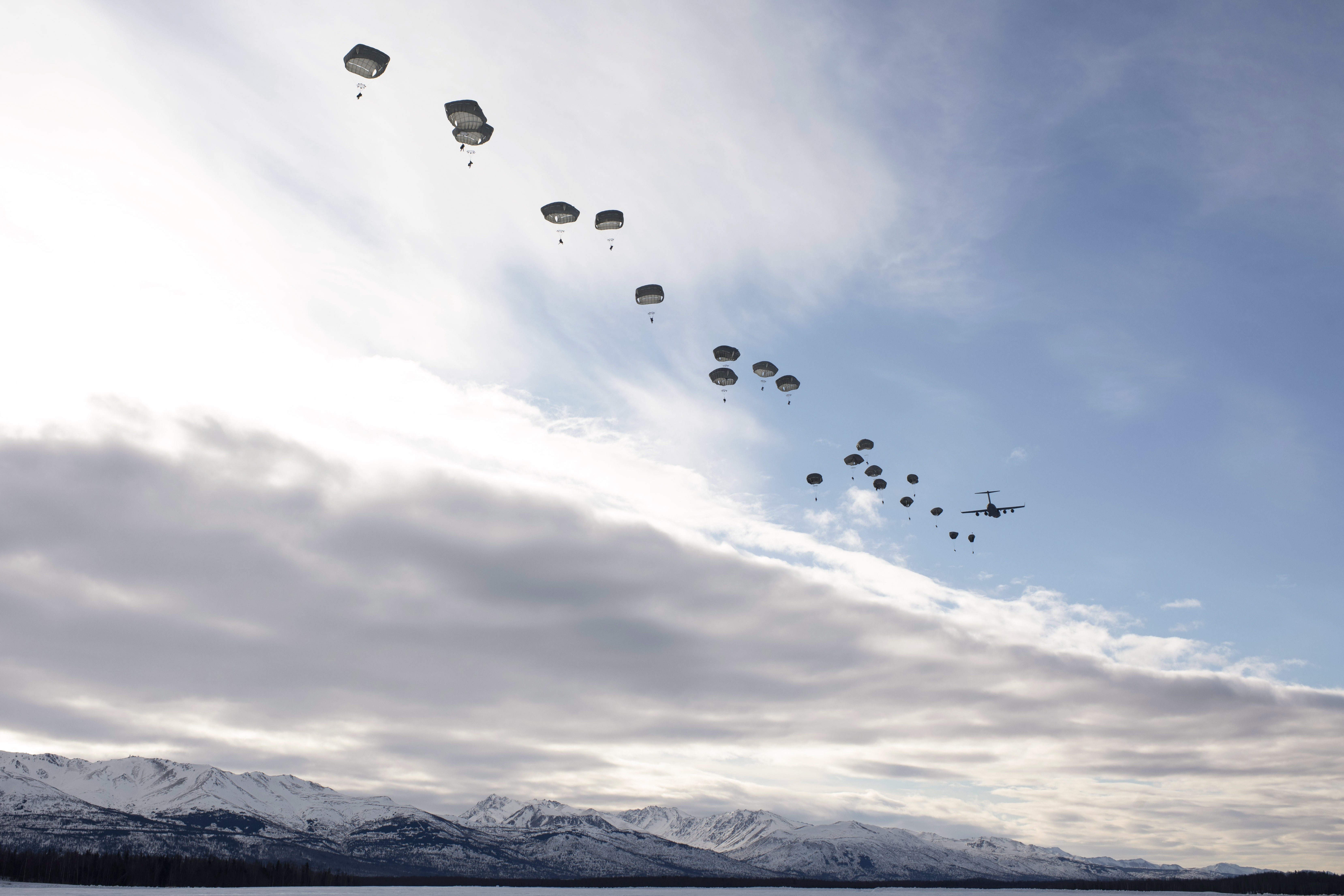 Soldiers jump from an Air Force C-17 Globemaster III during an all-female flight in honor of International Women's Day at Malemute Drop Zone at Joint Base Elmendorf-Richardson, Alaska, March 7, 2024.