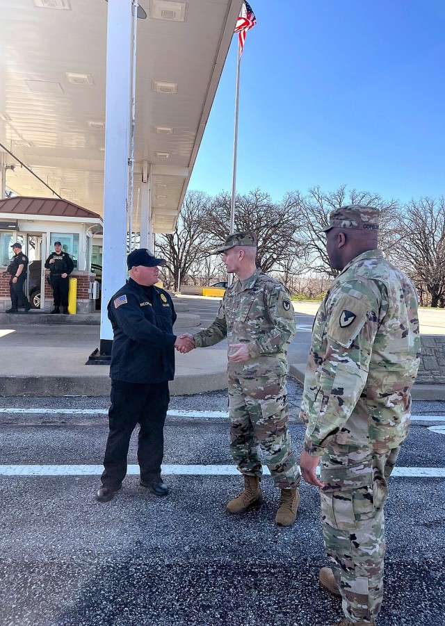 Department of the Army Security Guard Sgt. Jacob McGregor is thanked by Jones and IMCOM Command Sgt. Maj. Jason Copeland for his vigilance at the Fort Leavenworth access-control points March 19 at Grant Gate. Photo by Scott Gibson/Fort Leavenworth...