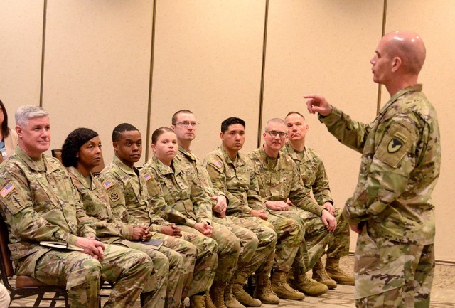 Fort Leavenworth Garrison Commander Col. Duane Mosier, Garrison Command Sgt. Maj. Erika Rhine-Russell and members of the Religious Service Organization listen to Installation Managment Command Commanding General Lt. Gen. Omar Jones address...
