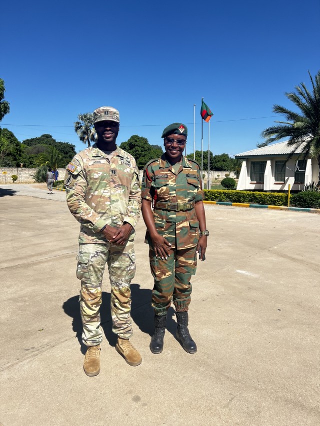 U.S. Army Capt. Kwame A. Addo, logistics officer, U.S. Army Southern European Task Force, Africa (SETAF-AF), poses for a photo with Zambian Army 2nd Lt. Esther Songe, public affairs officer, during the final planning event for the African Land Forces Summit 24 in Livingstone, Zambia, March 19, 2024. Sponsored by the U.S. Army Chief of Staff and co-hosted by SETAF-AF and the Zambia Army, ALFS 2024 will be held in Livingstone, April 22-26. The event will bring together senior leaders from across Africa, the U.S. and other partner nations to solidify relationships, exchange information on current topics of mutual interest and to encourage cooperation in addressing challenges. (U.S. Army photo by Neil Ruggiero)