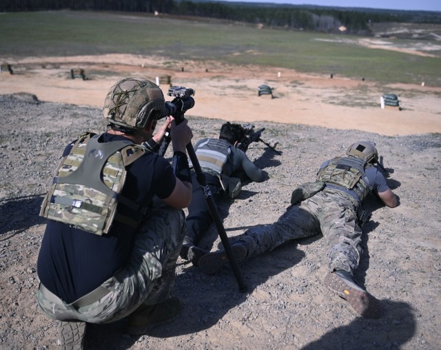 Competitors in the USASOC International Best Sniper Competition engage long-distance targets on a range at Fort Liberty, North Carolina, March 18, 2024.