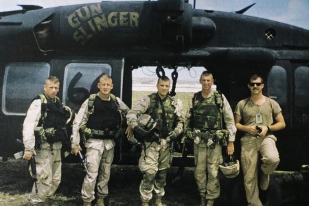Retired Army Maj. Larry Moores (second from left) is shown with leaders in front of Gunslinger and pilot from TF 160.   