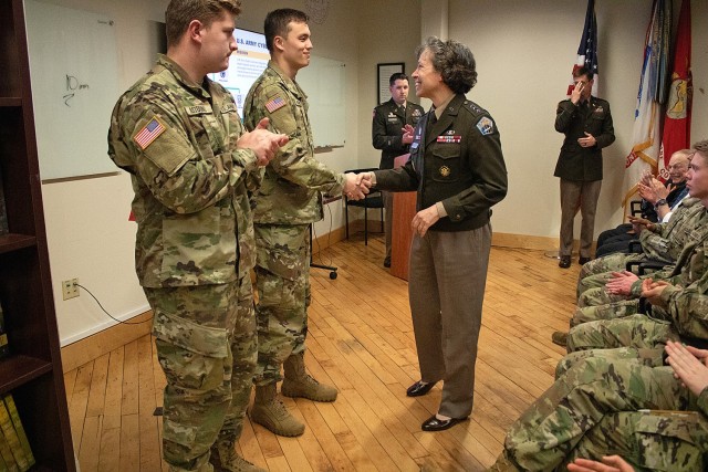 Lt. Gen. Maria Barrett, commander of Army Cyber Command (ARCYBER), presents ARCYBER coins to Cadet Jack Moore (shaking hands) and Cadet William Astorino (left) during a visit to the Massachusetts Institute of Technology&#39;s Reserve Officers&#39; Training Corps battalion. Barrett, a former member of the battalion, spoke with cadets and was inducted into the battalion hall of fame during her visit. (Photo by Cadet Giada James)