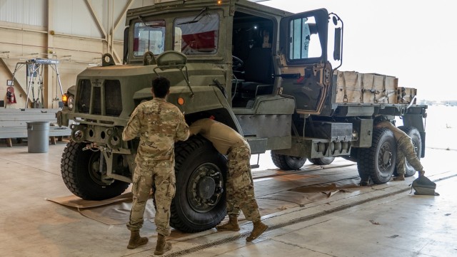 Airborne troops drop test new Family of Medium Tactical Vehicles at Ft. Liberty