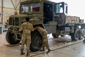 Airborne troops drop test new Family of Medium Tactical Vehicles at Ft. Liberty