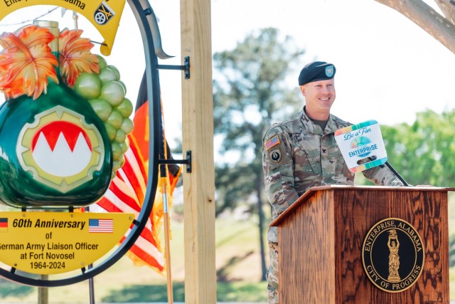 Col. Keith Hill, commander of the 110th Aviation Brigade, speaks to a crowd at Johnny Henderson Park in Enterprise, Ala. during the ceremony on March 28.