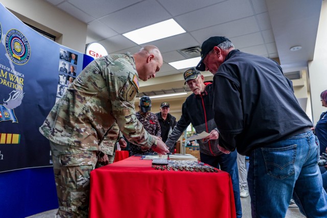 Colonel Chris Ricci, Garrison Commander, and Sgt. Major Sherman Waters, Command Sgt. Major, pin 50th anniversary pins for the Vietnam War on the lapels of multiple Vietnam veterans at Fort Knox, Ky., on Friday, March 29 2024. Col. Ricci expressed...