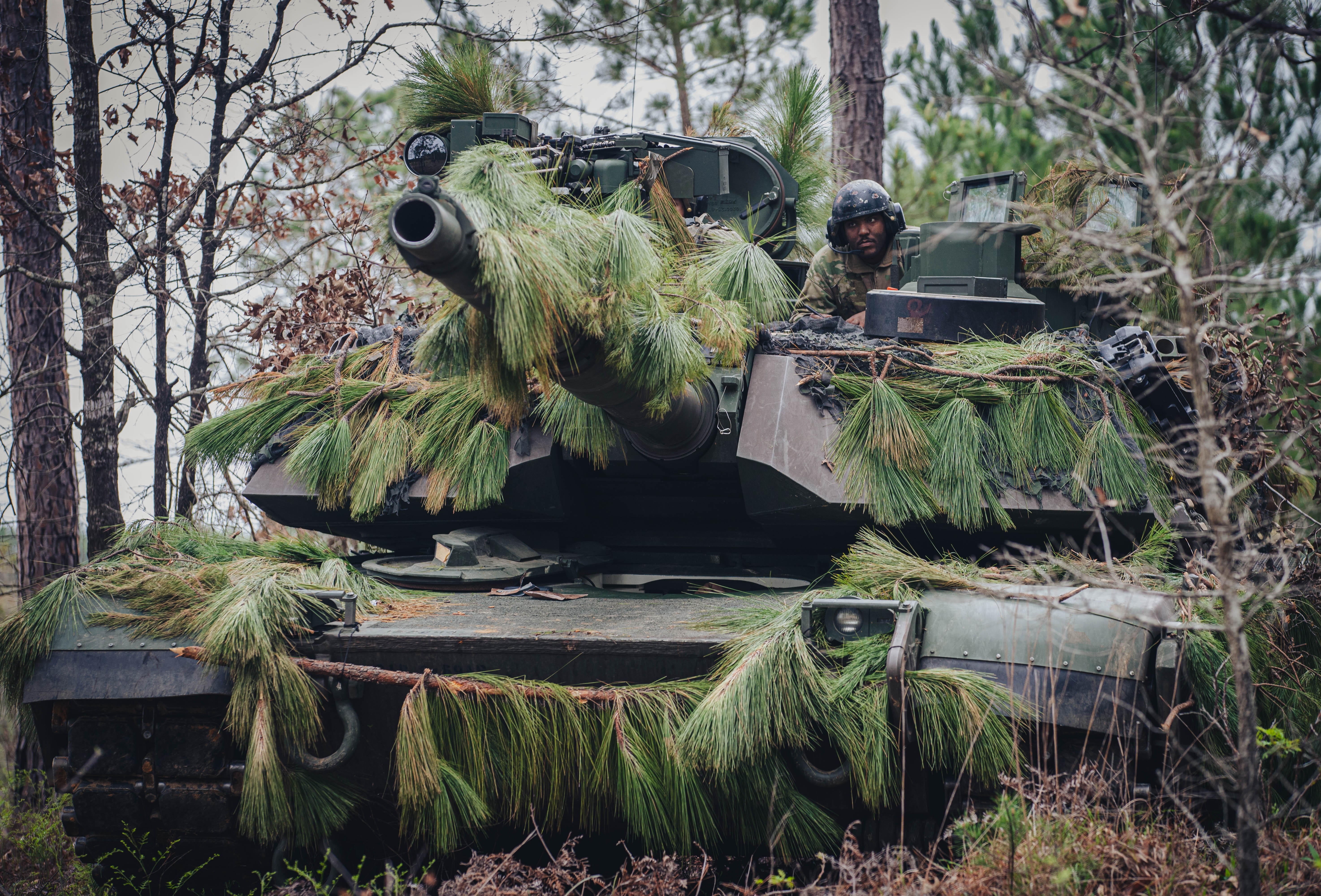 A Soldier assigned to 3rd Battalion, 69th Armor Regiment, 1st Armored Brigade Combat Team, 3rd Infantry Division, scouts a wooded area on top of an M1 Abrams Tank at the Joint Readiness Training Center (JRTC) at Fort Johnson, Louisiana, March 16,...