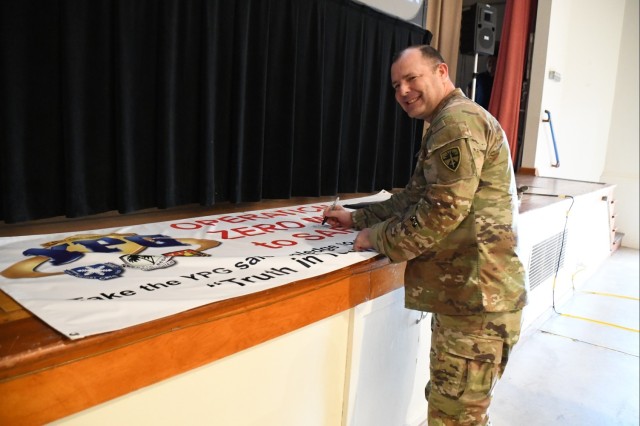 Yuma Proving Ground Commander Col. John Nelson was the first person to sign the Operation Zero Mils to Safety campaign banner following a kickoff event held in the Post Theater during a town hall meeting on Feb. 1, 2024. (Photos by Ana Henderson)
